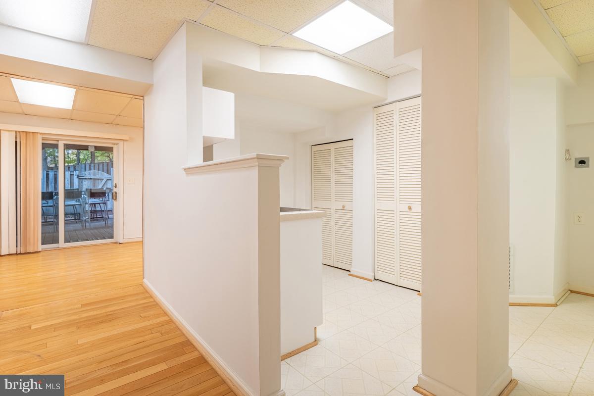 9256 Sprucewood Road Burke, VA 22015 - Photo 11 of 13 a view of a hallway with wooden floor and entryway