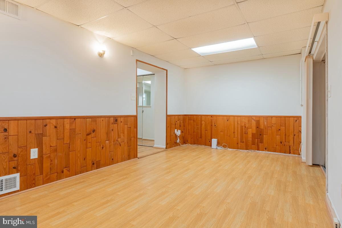 9256 Sprucewood Road Burke, VA 22015 - Photo 6 of 13 a view of an empty room and wooden floor