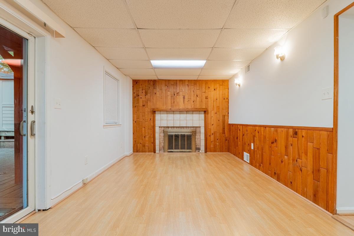 9256 Sprucewood Road Burke, VA 22015 - Photo 9 of 13 a view of an empty room with a fireplace