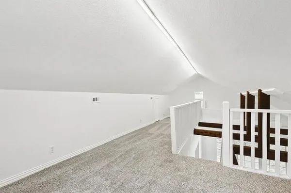 a view of an empty room with stairs