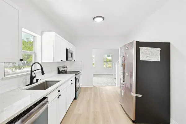 a kitchen with a sink and a refrigerator
