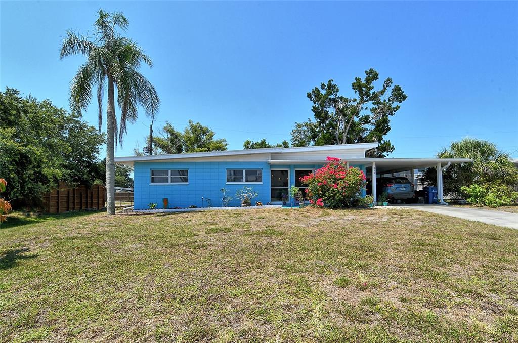 a front view of a house with a yard and a garage
