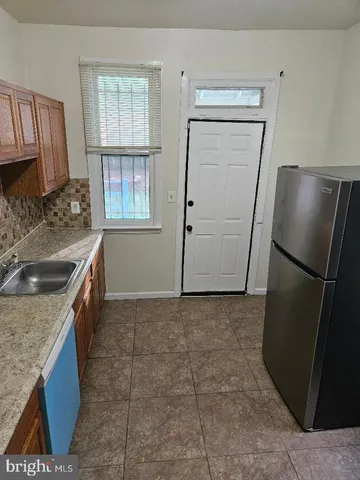 a kitchen with a sink stove and refrigerator
