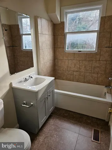 a bathroom with a sink a toilet and a bathtub
