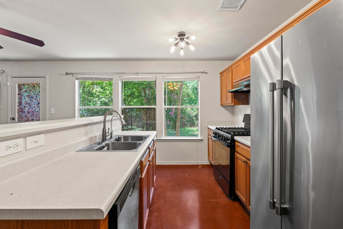 4608 Acers Lane Austin, TX 78725 - Photo 10 of 26 A stainless steel fridge and a gas cooktop grace the kitchen.