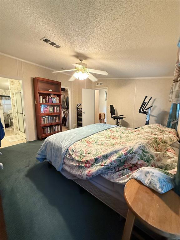 5109 Southwest 10th Street Bell, FL 32619 - Photo 36 of 38 a bedroom with a large bed and a bookshelf