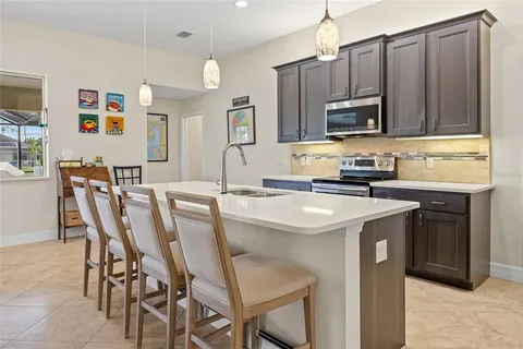 a kitchen with stainless steel appliances a stove a sink refrigerator and microwave