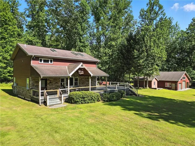 a front view of a house with a yard table and chairs