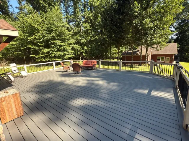 a view of a swimming pool with a patio and a yard