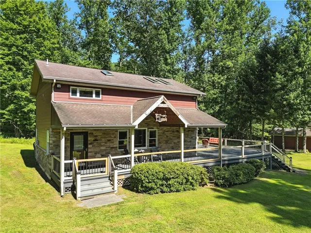 a front view of a house with a garden