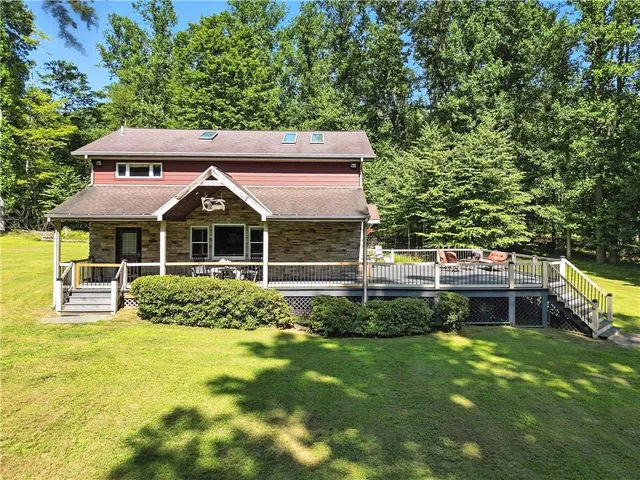 a front view of a house with a yard table and chairs