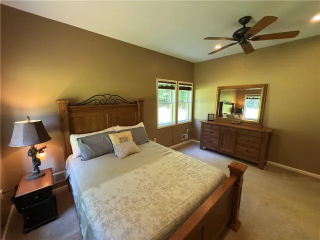 a living room with a bed furniture and a flat screen tv