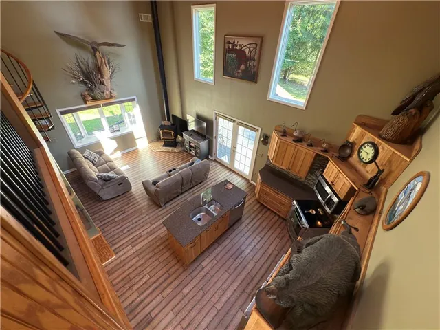 a view of a livingroom with furniture wooden floor windows and a flat screen tv