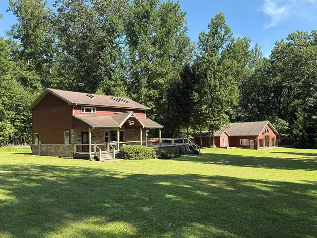 a front view of a house with a garden