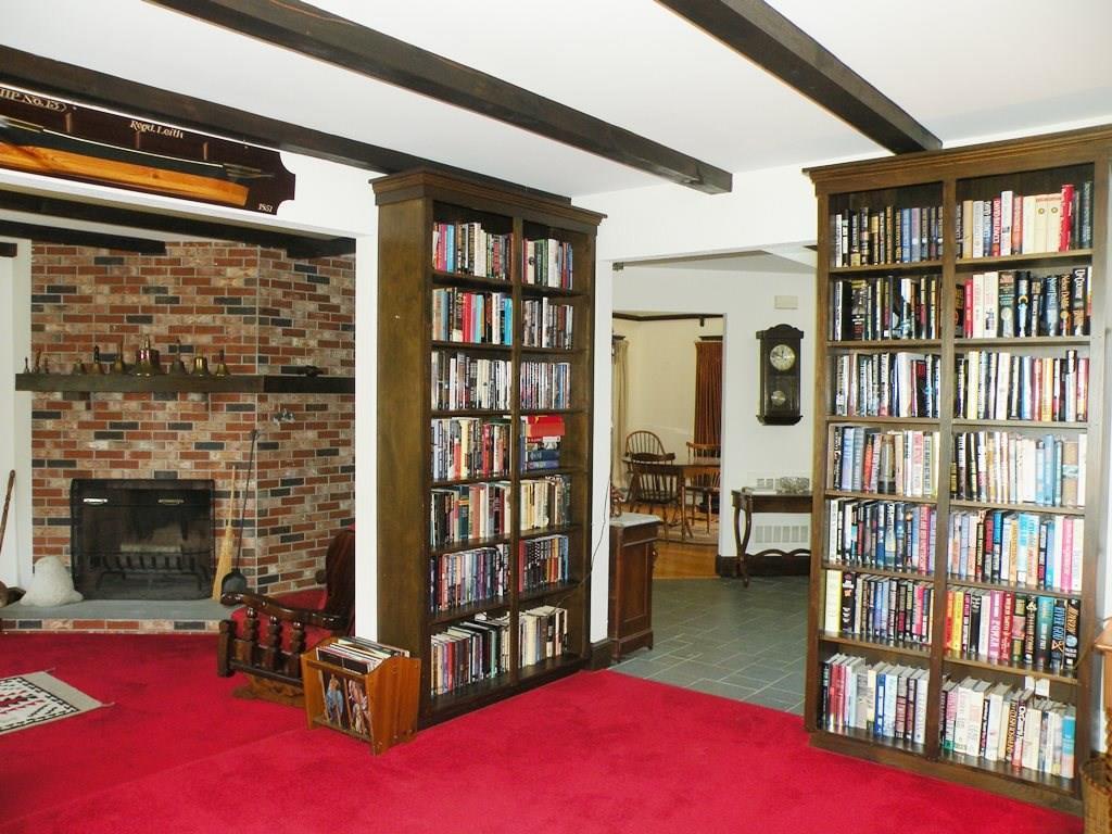 235 Flaggy Meadow Road Gorham, ME 04038 - Photo 17 of 35 Library opens to fireplaced living room
