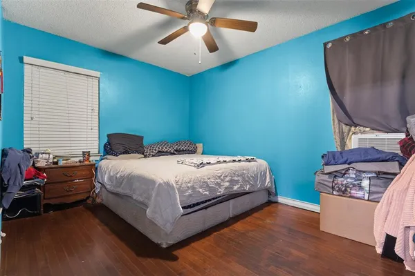 a bedroom with a bed window and a chair