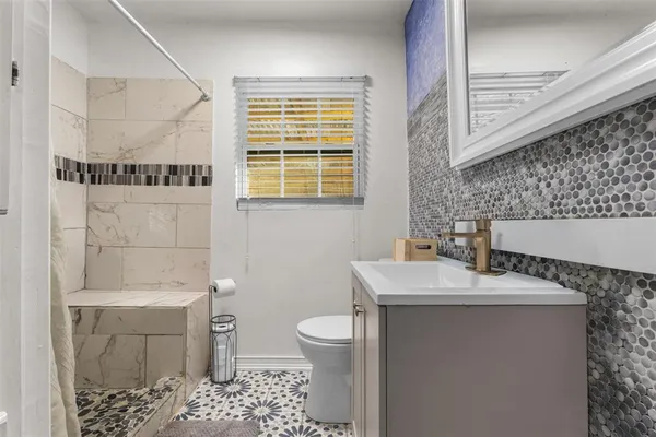 a bathroom with a sink toilet and shower