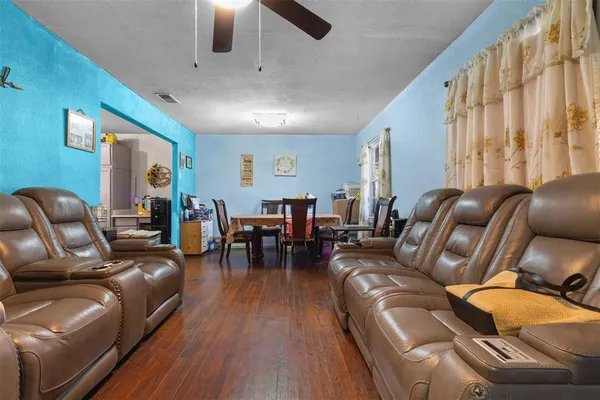 a living room with furniture and wooden floor