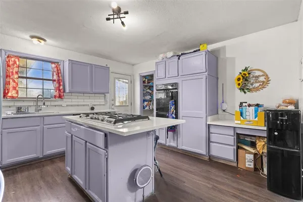 a kitchen with a stove a refrigerator and a sink