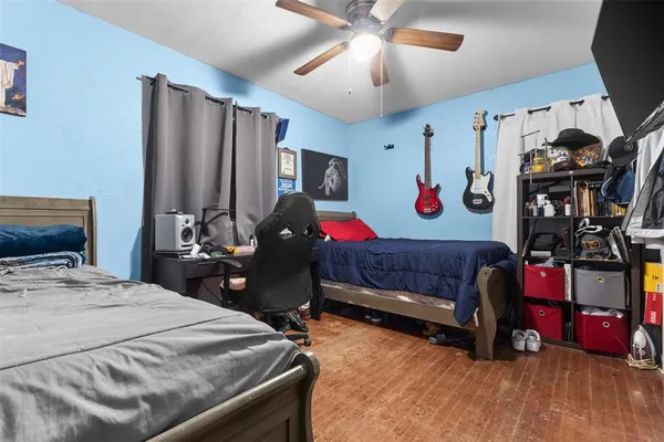 a bedroom with bed and a chandelier