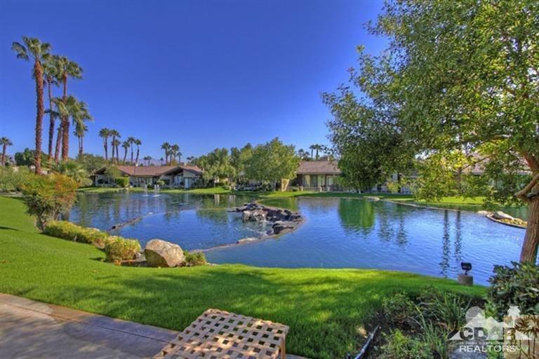 383 Red River Road Palm Desert, CA 92211 - Photo 1 of 2 a view of a lake with a house in the background