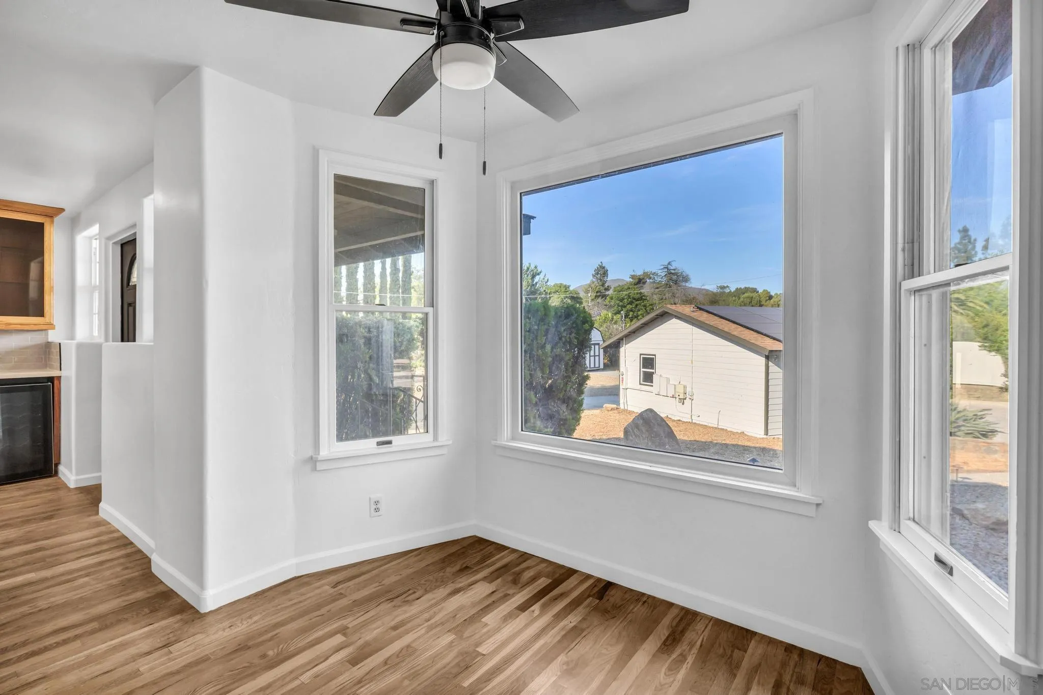 1230 Arnold Way Alpine, CA 91901 - Photo 13 of 60 a view of an empty room with wooden floor and a window
