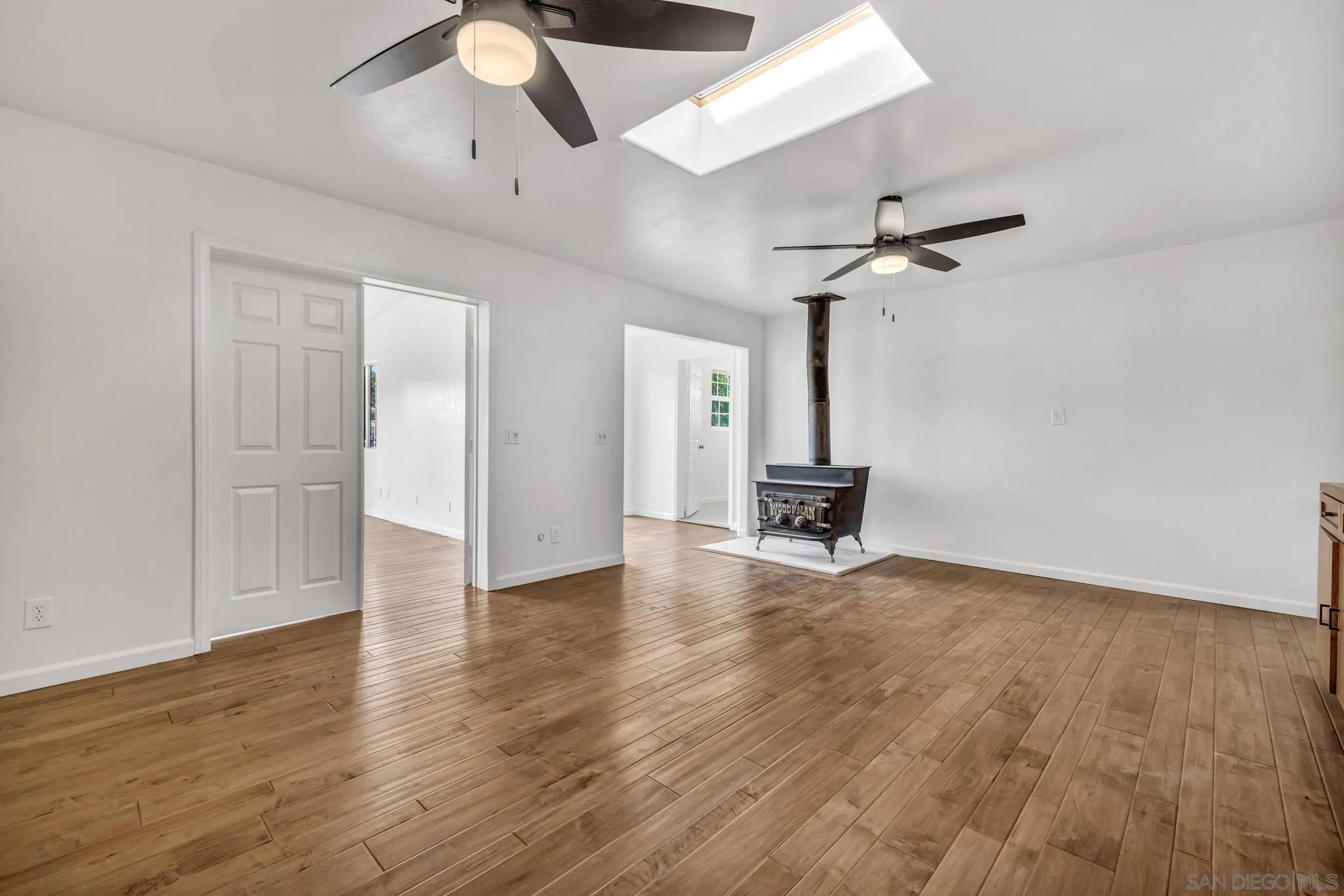 1230 Arnold Way Alpine, CA 91901 - Photo 25 of 60 a view of a livingroom with wooden floor and a ceiling fan