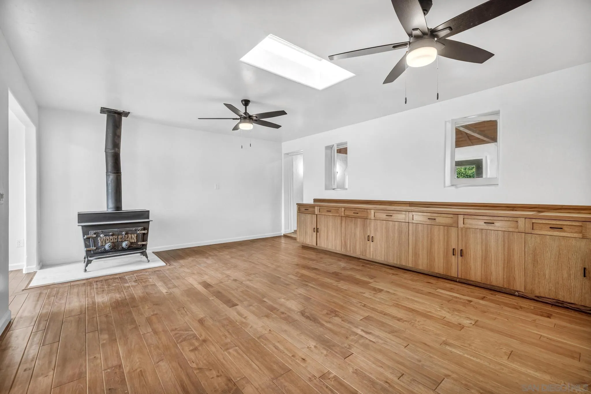 1230 Arnold Way Alpine, CA 91901 - Photo 26 of 60 a view of an empty room with a window and wooden floor