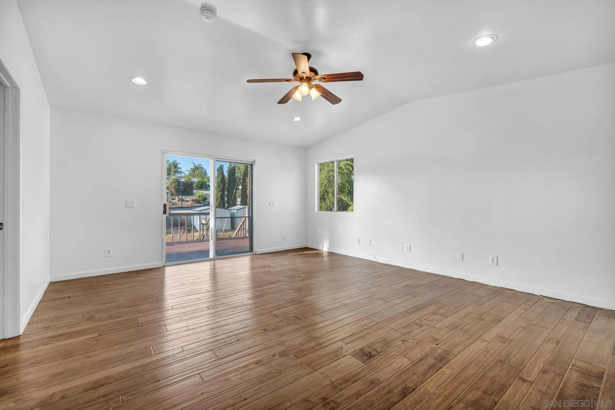 1230 Arnold Way Alpine, CA 91901 - Photo 30 of 60 an empty room with wooden floor fan and windows