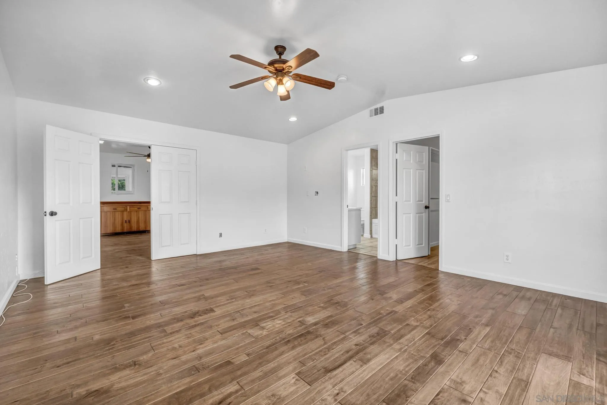 1230 Arnold Way Alpine, CA 91901 - Photo 31 of 60 a view of an empty room with wooden floor and a ceiling fan