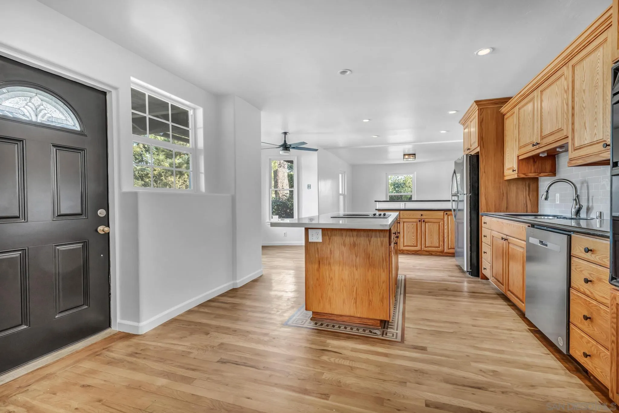 1230 Arnold Way Alpine, CA 91901 - Photo 10 of 60 a large kitchen with stainless steel appliances kitchen island granite countertop a large counter top and a stove top oven