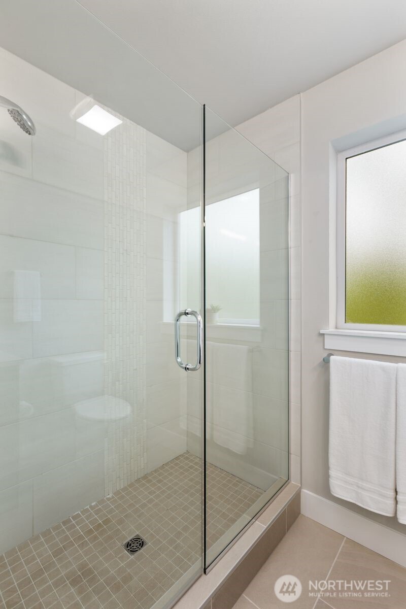 826 238th Place Southeast, Unit F Bothell, WA 98021 - Photo 16 of 39 a bathroom with a glass shower door