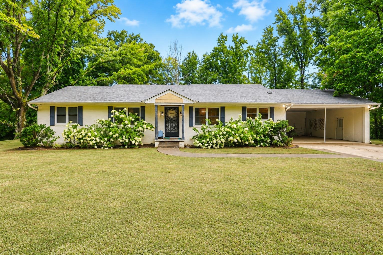 10093 Mt Carmel Road Brighton, TN 38011 - Photo 1 of 36 Ranch-style exterior with a covered carport, expansive front lawn, and mature trees