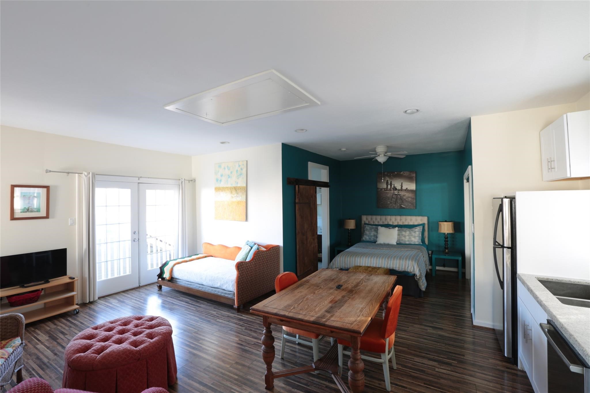 1625 Harvard Street, Unit B Houston, TX 77008 - Photo 2 of 9 a bedroom with furniture and a fireplace