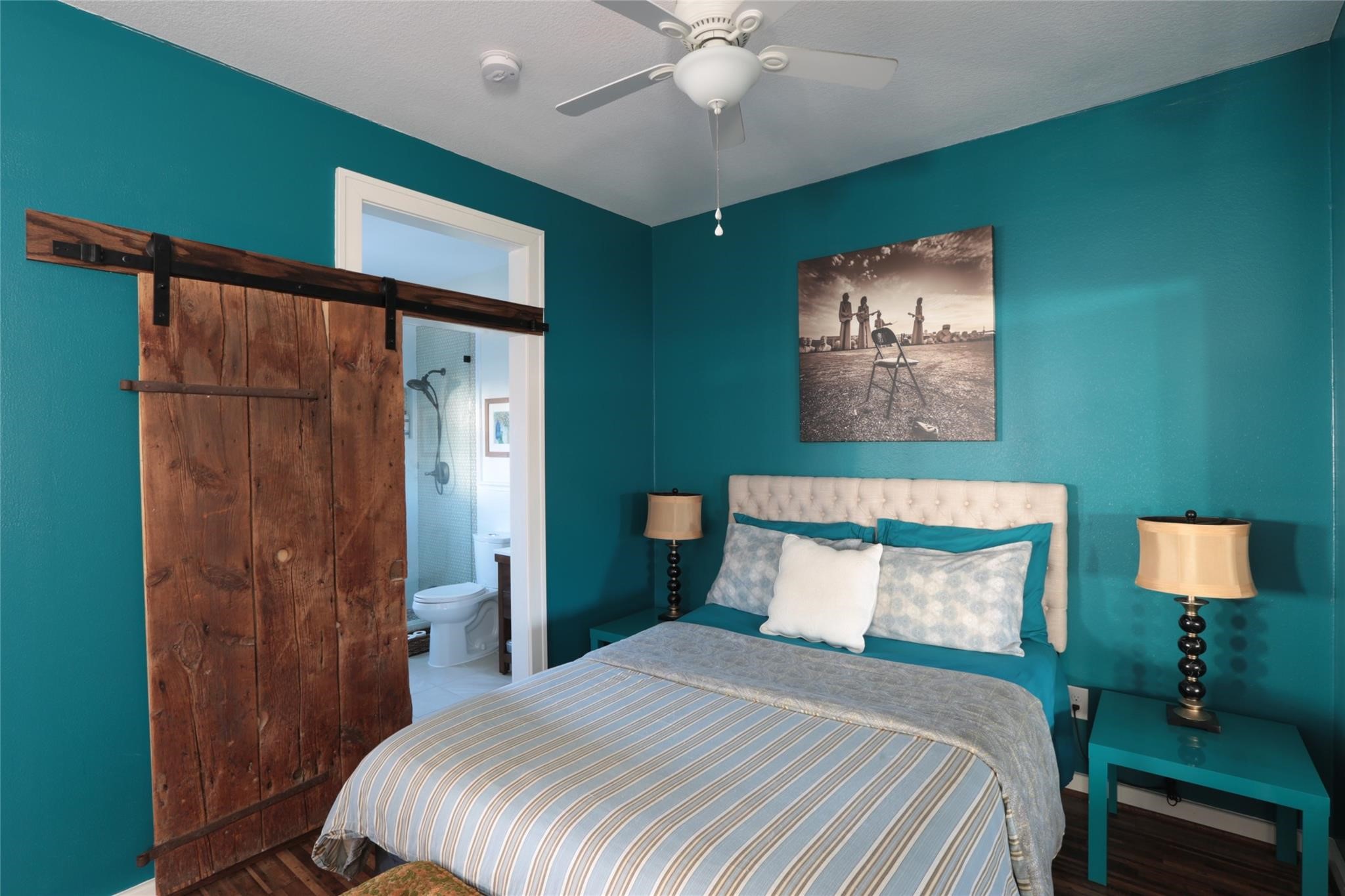 1625 Harvard Street, Unit B Houston, TX 77008 - Photo 3 of 9 a bedroom with a bed and a chandelier