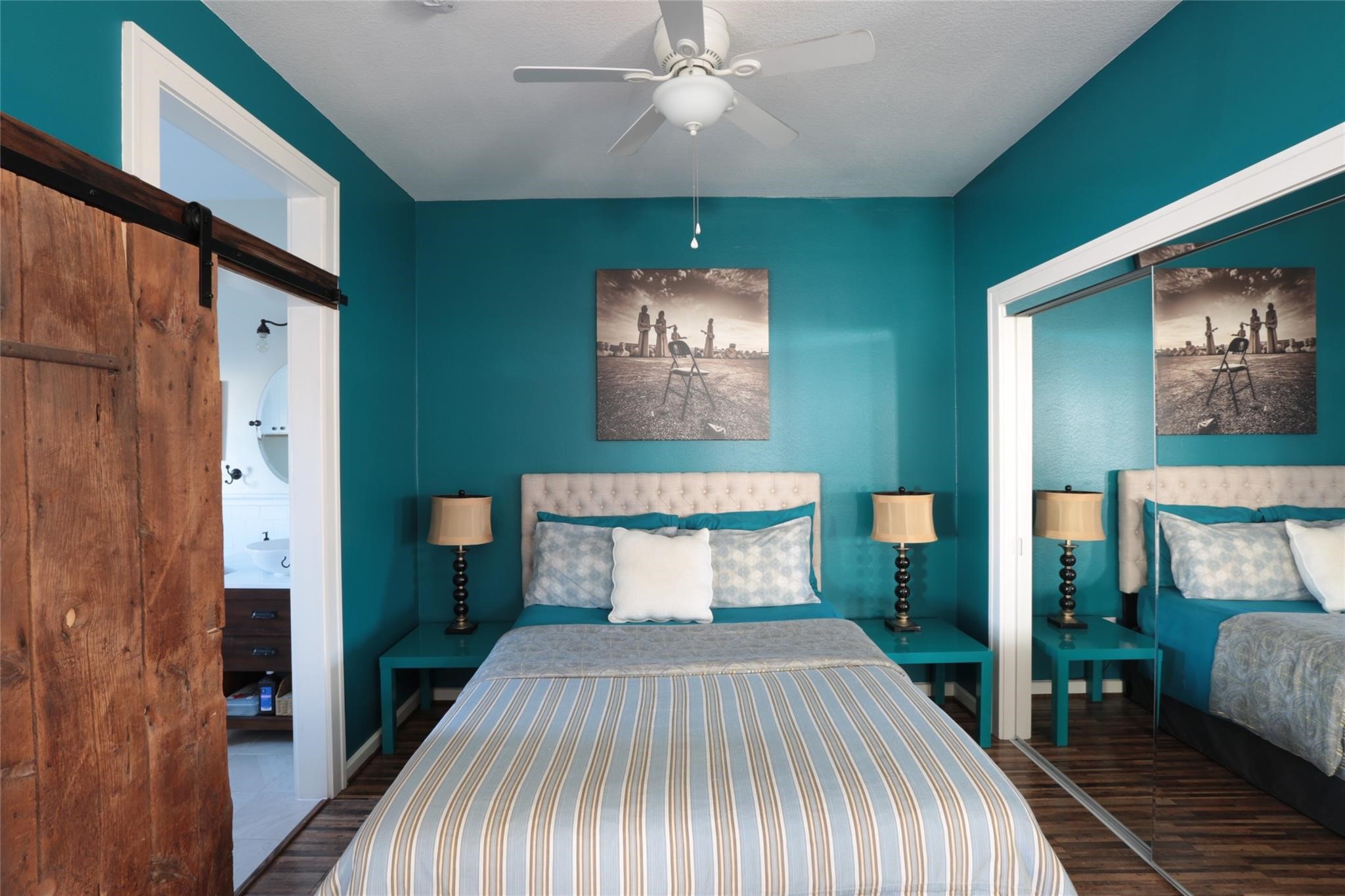 1625 Harvard Street, Unit B Houston, TX 77008 - Photo 4 of 9 a bedroom with a bed and a chandelier