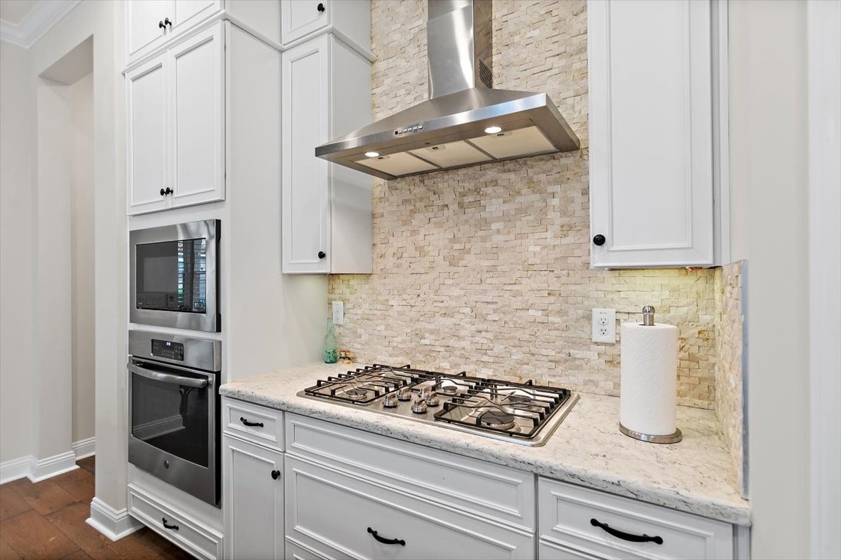 96014 Enclave Manor Fernandina Beach, FL 32034 - Photo 7 of 32 a kitchen with white cabinets and appliances