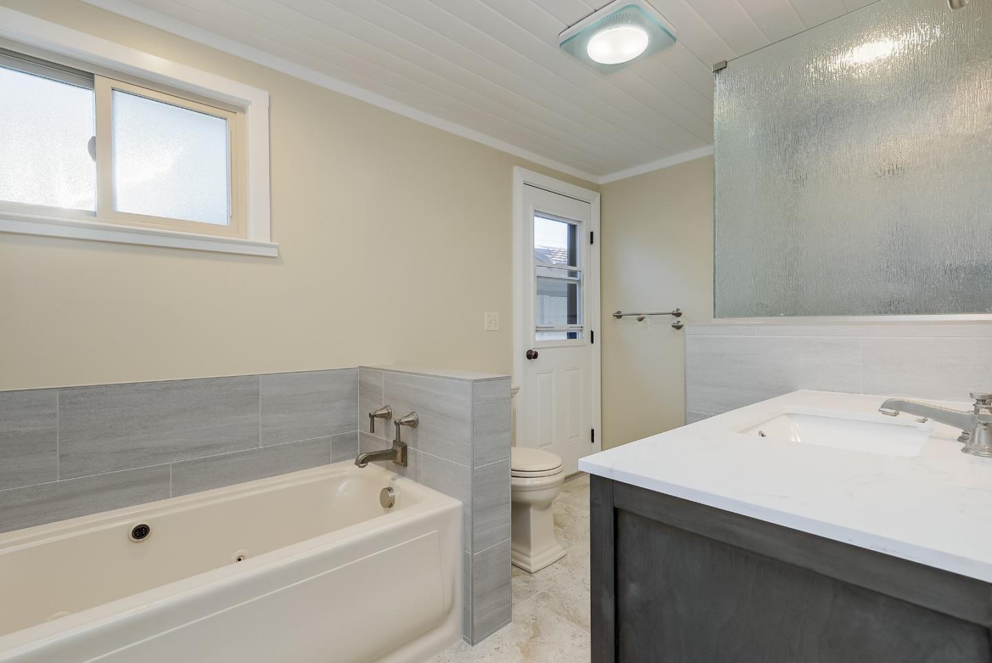 1249 Lime Drive Sunnyvale, CA 94087 - Photo 11 of 24 a bathroom with a tub sink and mirror