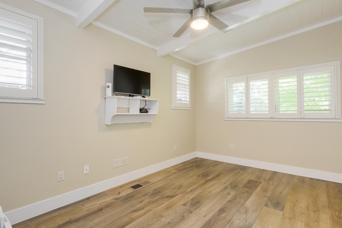 1249 Lime Drive Sunnyvale, CA 94087 - Photo 16 of 24 a view of a livingroom with wooden floor a ceiling fan and windows