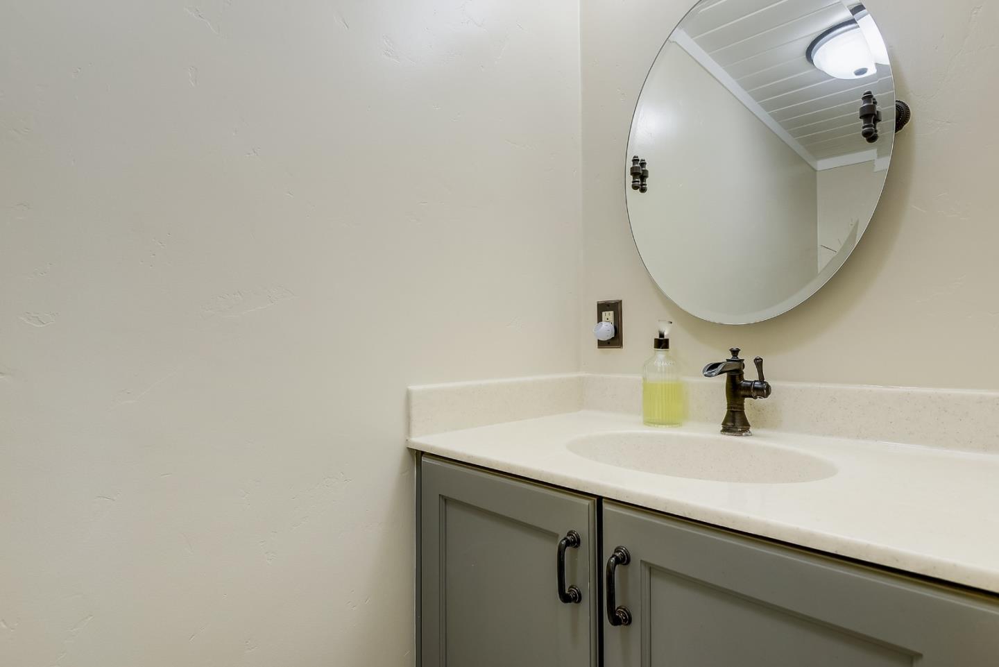 1249 Lime Drive Sunnyvale, CA 94087 - Photo 18 of 24 a bathroom with a sink and a mirror
