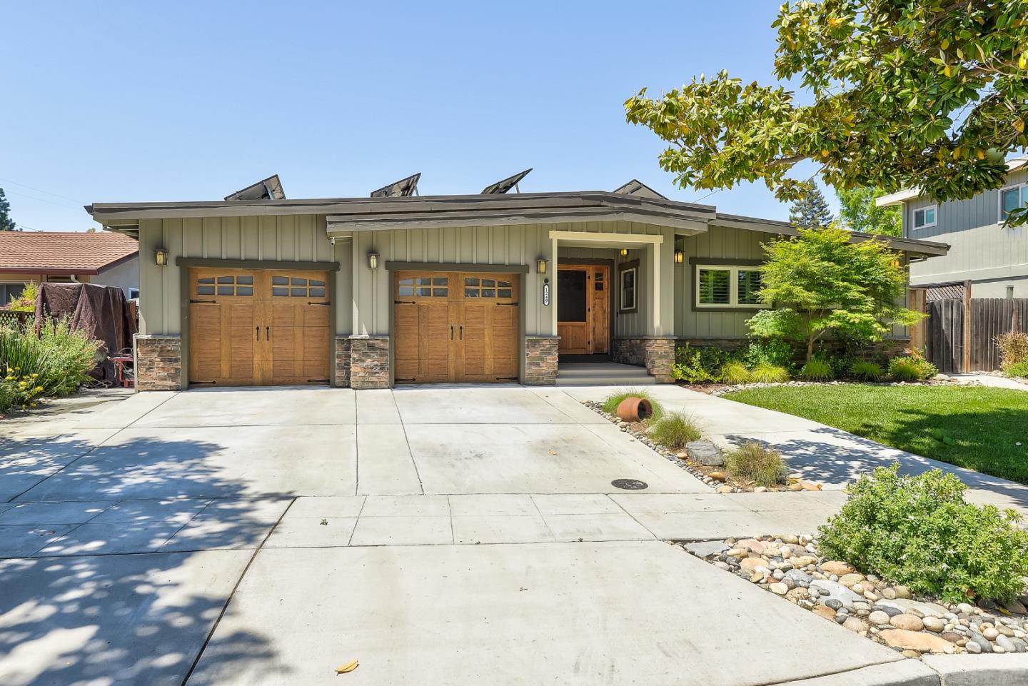 1249 Lime Drive Sunnyvale, CA 94087 - Photo 2 of 24 a front view of a house with a yard and a garage