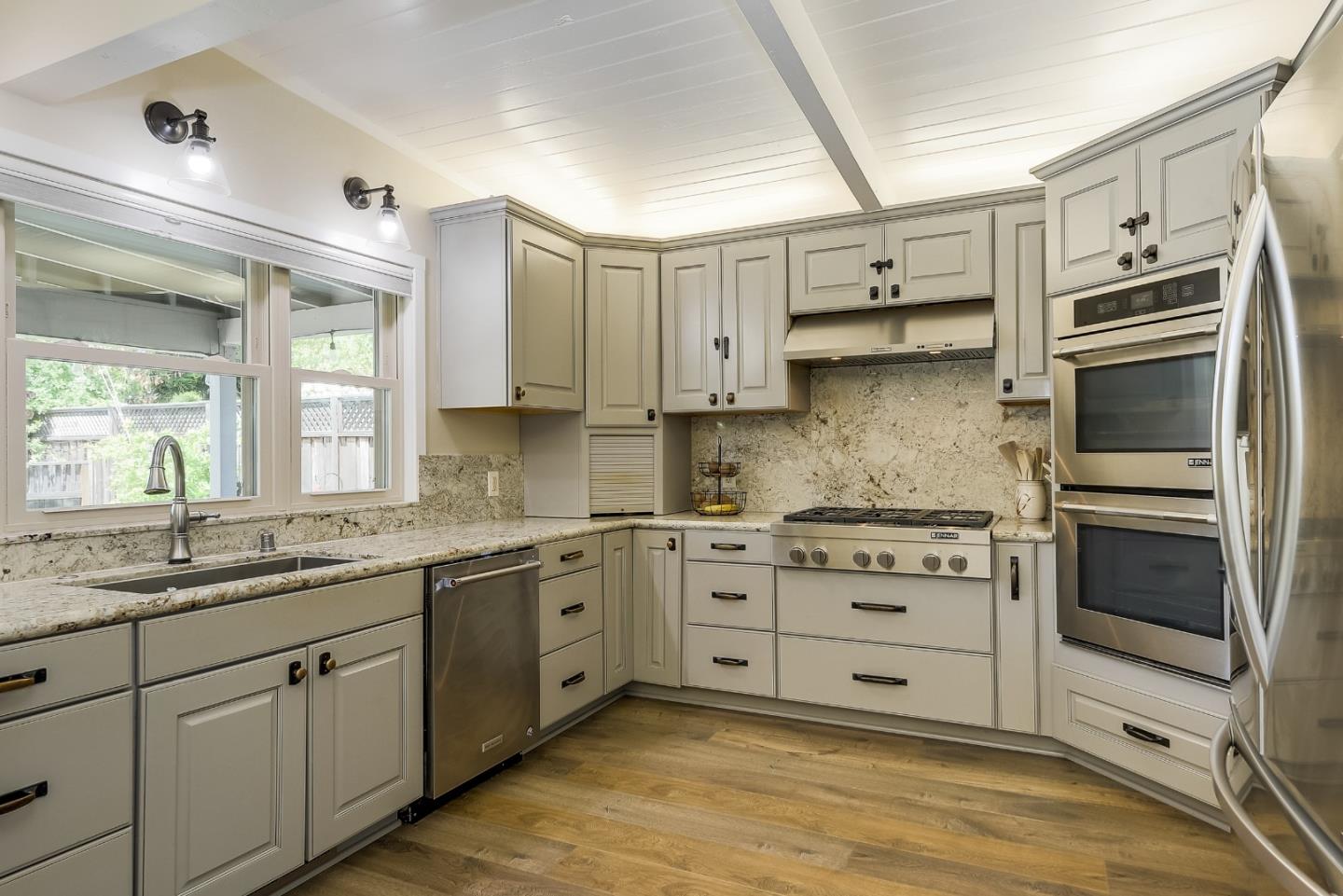 1249 Lime Drive Sunnyvale, CA 94087 - Photo 7 of 24 a kitchen with stainless steel appliances granite countertop a stove and a sink