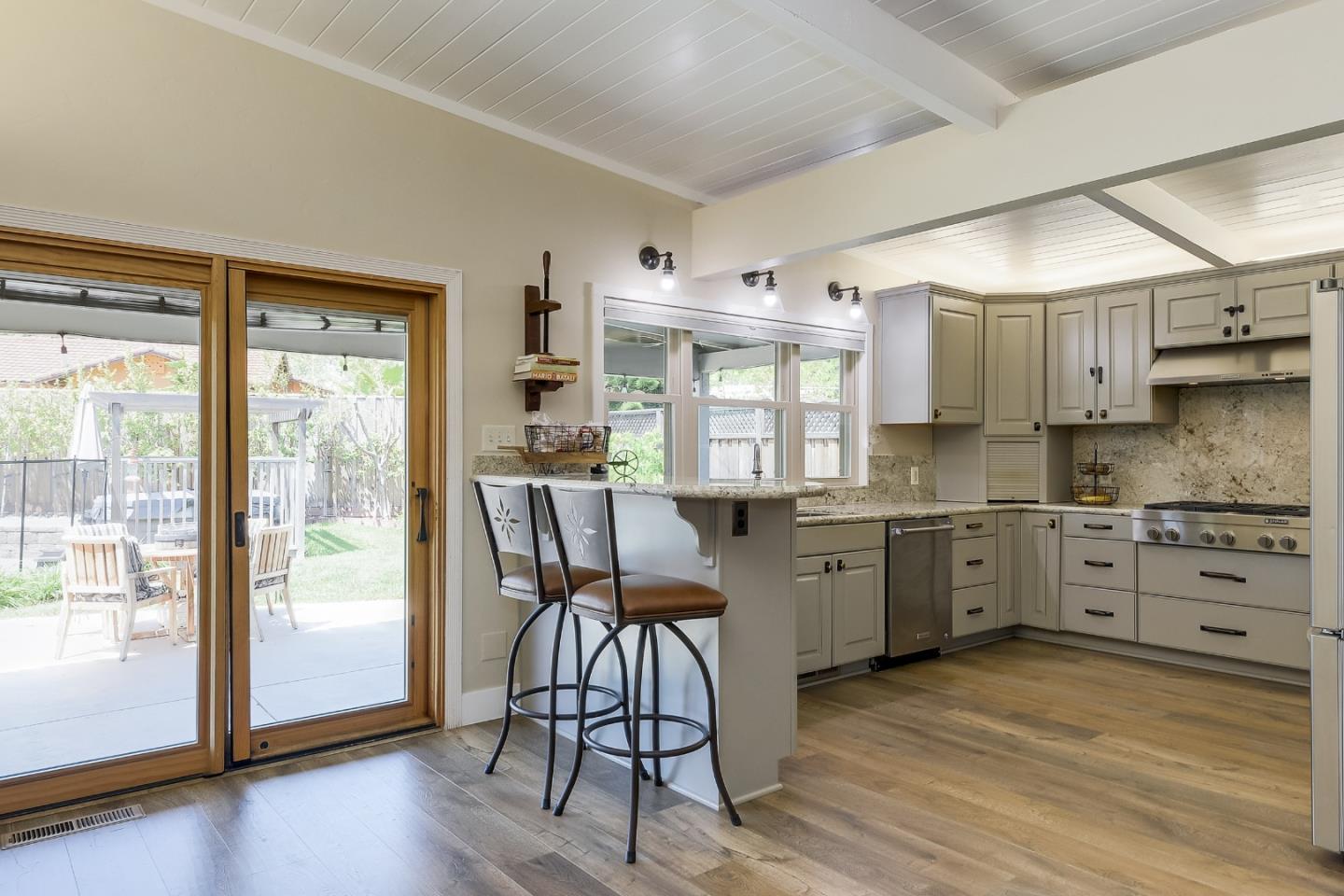 1249 Lime Drive Sunnyvale, CA 94087 - Photo 8 of 24 a kitchen with granite countertop a stove a sink and a refrigerator