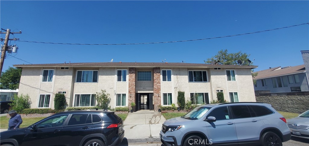 24522 Chestnut Street Newhall, CA 91321 - Photo 1 of 7 a front view of a house with parking space