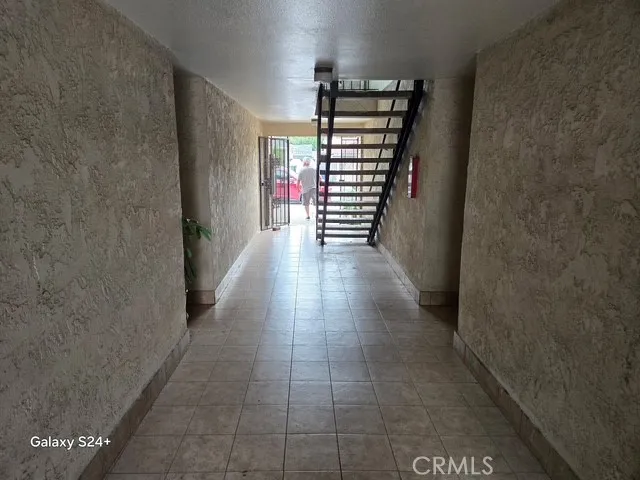 a view of a hallway with wooden floor and stairs