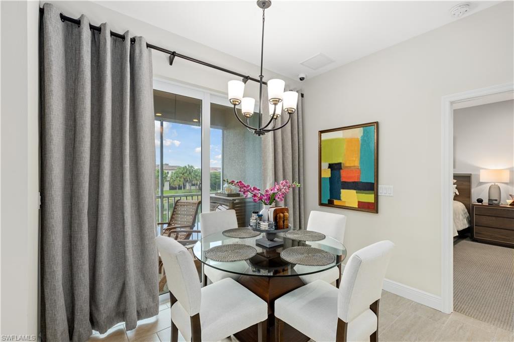 2311 Sawyers Hill Road, Unit 805 Naples, FL 34120 - Photo 11 of 27 a view of a dining room with furniture window and wooden floor