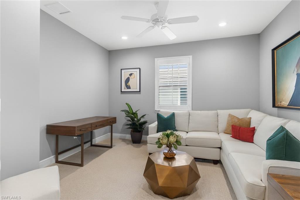 2311 Sawyers Hill Road, Unit 805 Naples, FL 34120 - Photo 13 of 27 a living room with furniture and a potted plant
