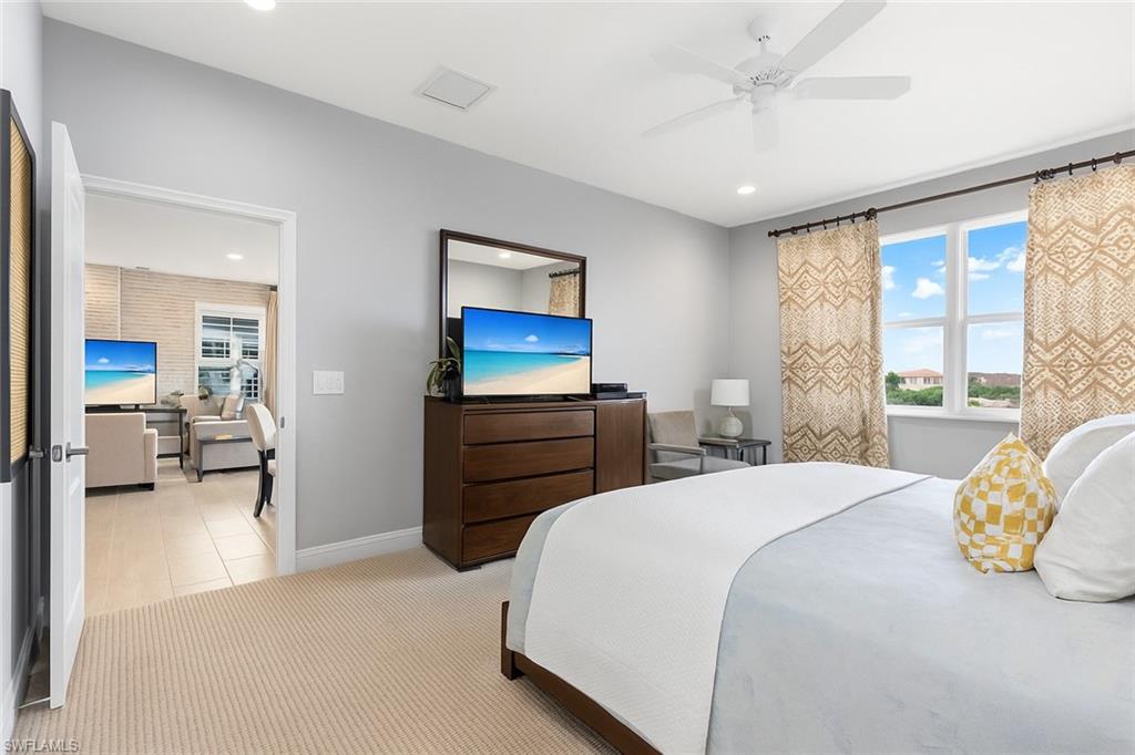 2311 Sawyers Hill Road, Unit 805 Naples, FL 34120 - Photo 15 of 27 a bedroom with a bed and a couch
