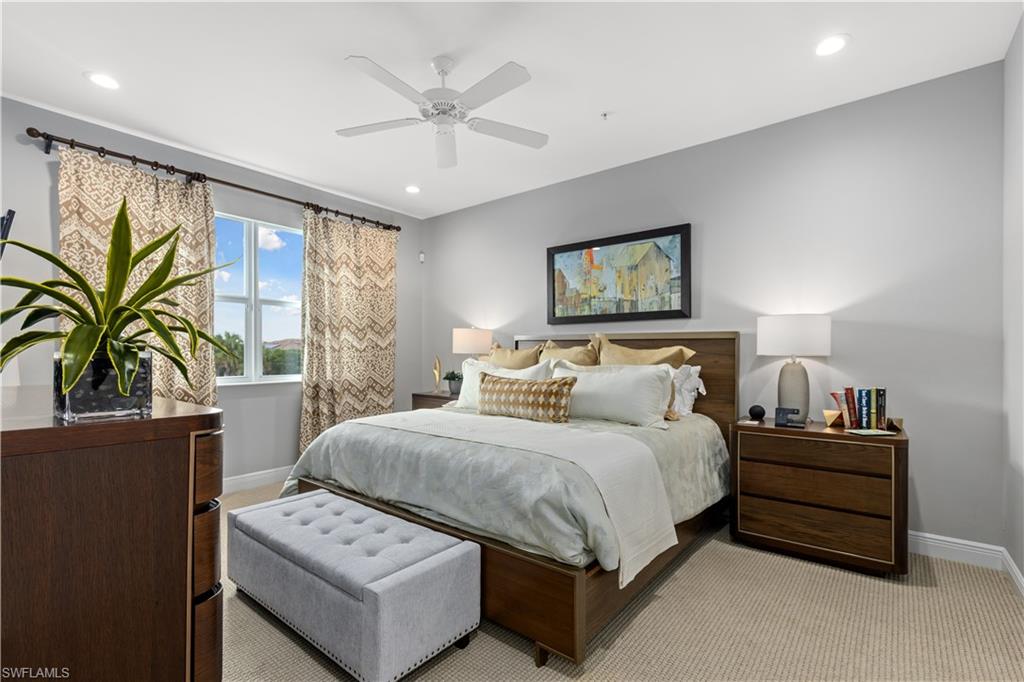 2311 Sawyers Hill Road, Unit 805 Naples, FL 34120 - Photo 18 of 27 a spacious bedroom with a bed a couch and a large window