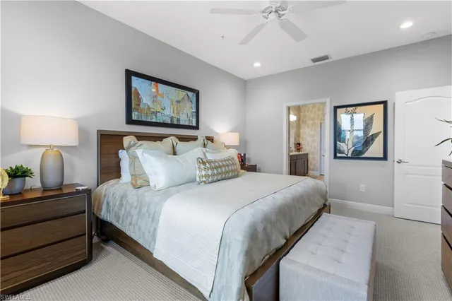 a bedroom with bed and a chandelier